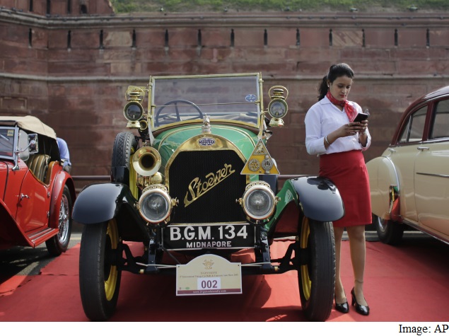 girl_using_mobile_at_vintage_car_rally_ap.jpg